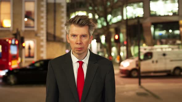 Businessman looking at camera at night