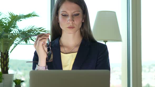 Attractive Business Woman Working in Office on Computer Desk