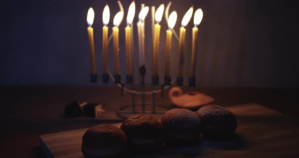 Hanukkah powdered doughnuts and a menorah