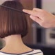 Hairdresser-stylist is cutting hair of a girl client - VideoHive Item for Sale