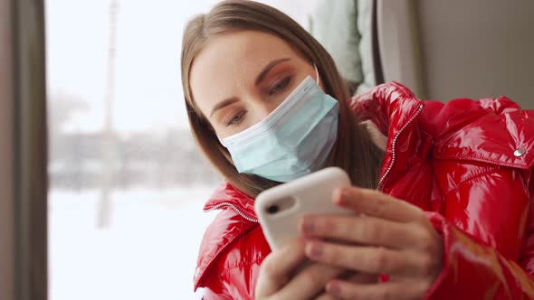 Woman Uses Mobile Phone on Way to Work in Public Transport