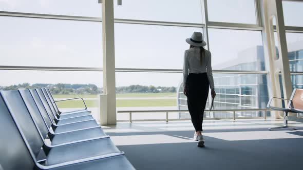 Girl Tourist Freelancer Works and Waits for Flight in Waiting Room