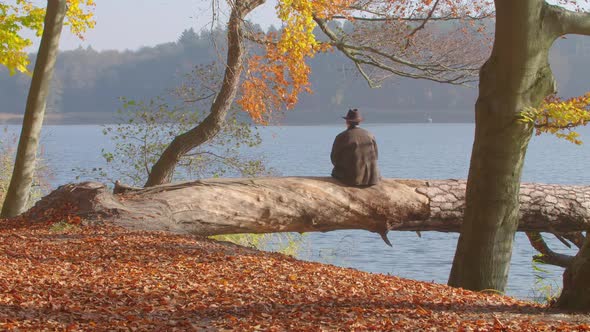 A Mid Aged Man Looks over a Autumnal Lake