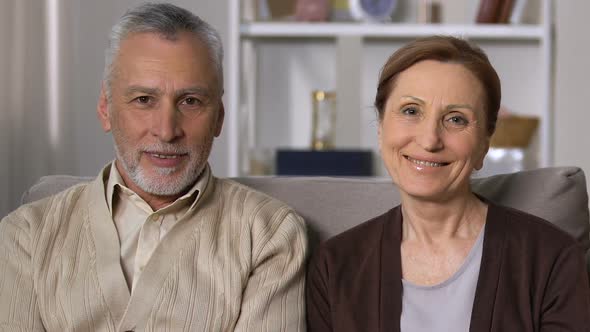 Happy Retired Couple Looking Camera Sitting Sofa, Old Age Vitality, Health