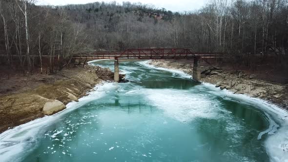 Push In Shot of Rusty Old Mountain Footbridge in Winter