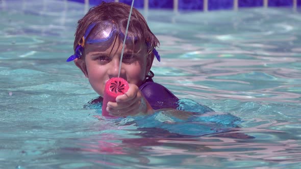 A boy plays in a pool at a hotel resort.