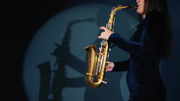 Woman Plays on Saxophone. Musical Concept