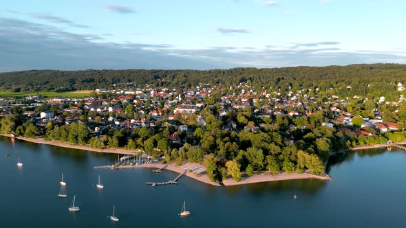 Aerial view flying drone of town Herrsching at Ammersee lake, luxurious residential area with high c