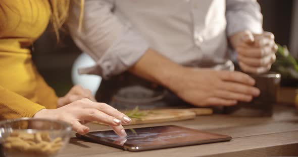 Couple Prepare Together Dinner at Home in the Evening Closeup