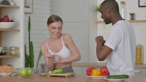 Sporty African Man and Woman Dancing in Kitchen
