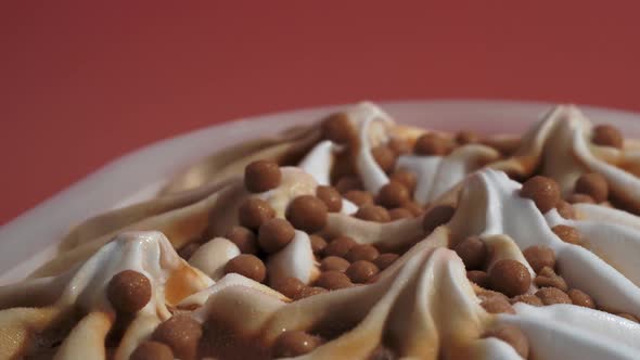 Caramel Ice Cream Rotates on a Pink Background