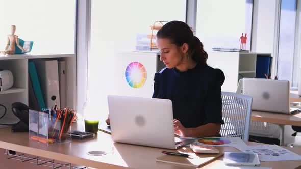 Female executive working at her desk in office