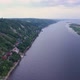 Camera is Flying Over Wide River Along Shore with Small Houses Aerial View of Landscape - VideoHive Item for Sale