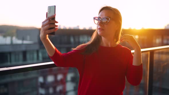 Woman Taking Selfie on the Balcony