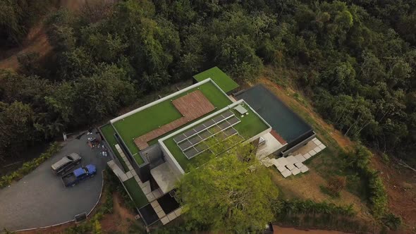 Modern home with solar panels in a tropical forest.