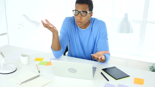 Afro-American Man Angry at Work, Reacting to Boss