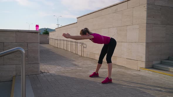 Sporty Girl Starts Day with Morning Exercises Outdoor