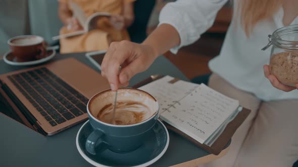 Two Girls Meet in a Coffee Shop