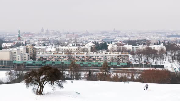 View From Kopiec Krakusa  Man Walking with His Dog On The Snowy Landscape