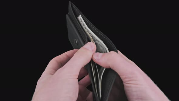 Male Hands Show a Black Wallet with Some Dollar Bills on Alpha Channel