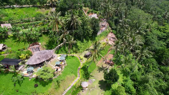 eco bamboo hut on a hill with coconut trees in ubud bali indonesia, aerial