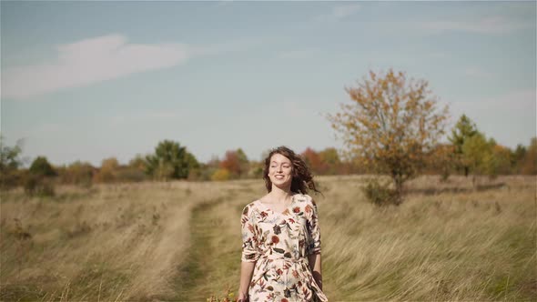 Portrait of Positive Smiling Woman Looking Into Camera at Sunset