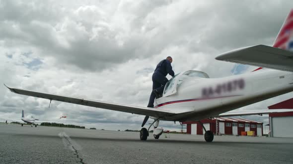 Mature Pilot Getting into Airplane