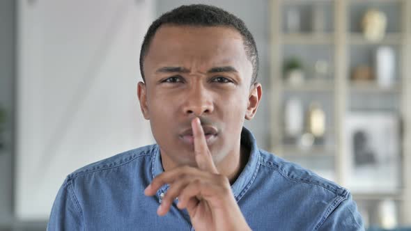 Finger on Lips of Young African Man, Silent