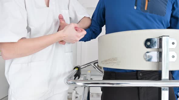 Close Up of Physiotherapist Assisting a Patient with Amyotrophic Lateral Sclerosis