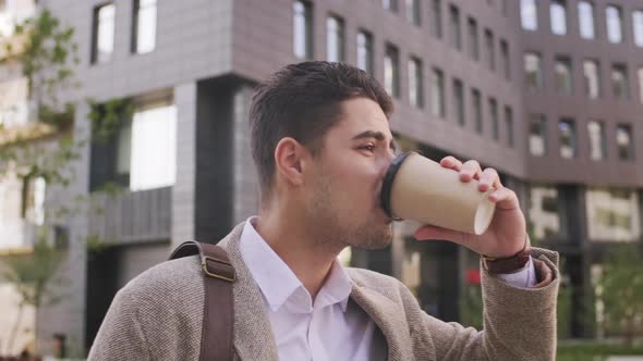  Handsome Businessman Drinking Coffee and Walking to Work