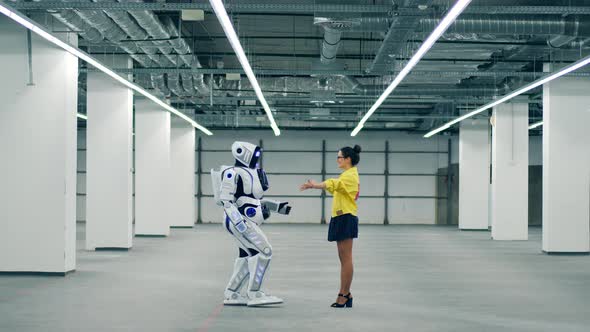 Robotic Anthropoid and a Lady Are Holding Each Other