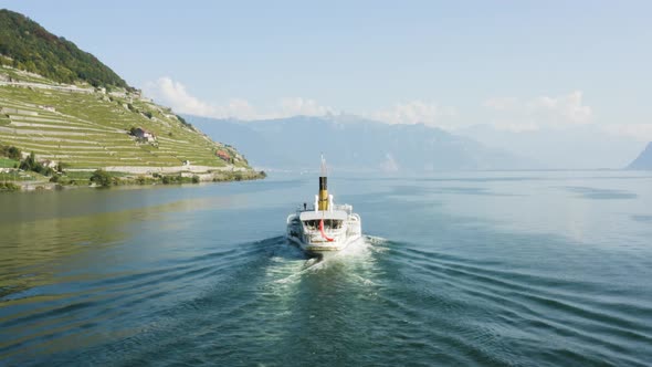Aerial shot following CGN Belle-Epoque steam boat on Lake Léman in front of Lavaux vineyard.Switzer