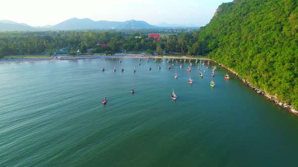 Many fishing boats on the coast beside the mountains, beautiful sea area in Thailand.