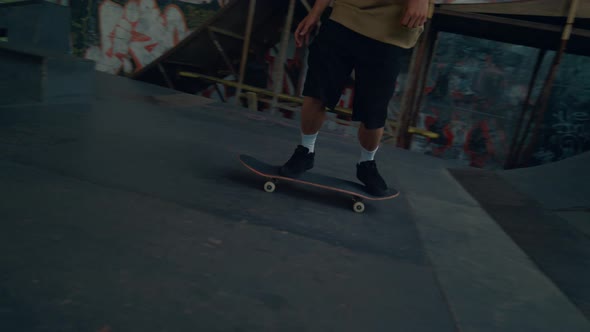 Skate Boarder Doing Tricks in Bowl at Urban Skatepark