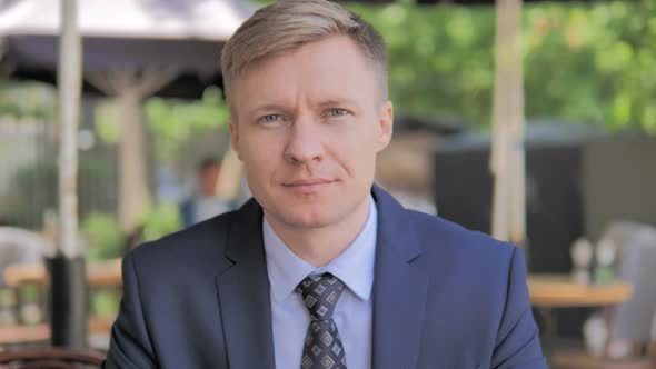 Outdoor Portrait of Serious Businessman