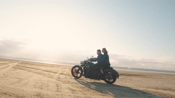 Guy with a Girl on a Motorcycle in the Desert