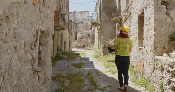 Female engineer looking at the city after the earthquake disaster