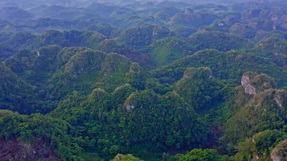 Flying over the picturesque forested green hills in Los Haitises National Park, Dominican Republic -