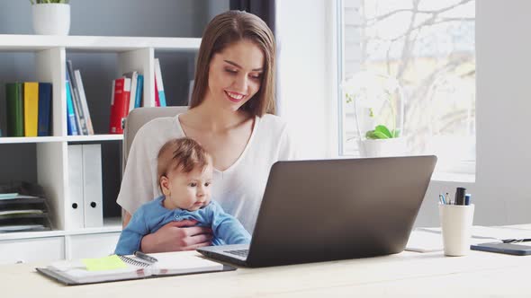 Young Woman Works at Home Office Using Computer.