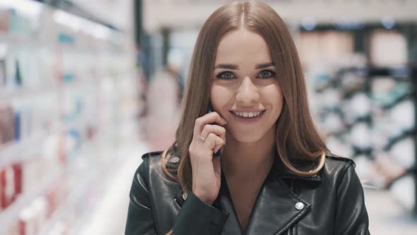 Caucasian Positive Beautiful Young Smiling Girl Talking on Smartphone