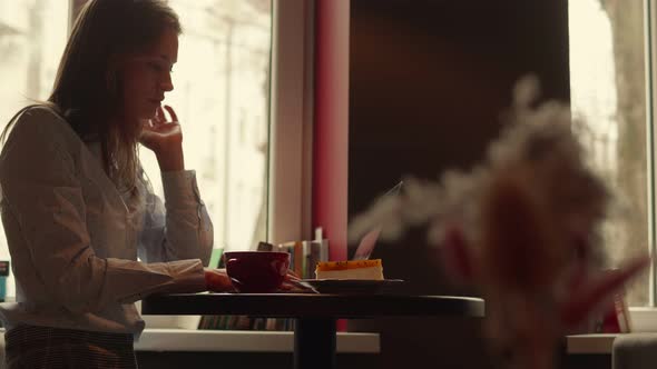 Young Business Woman Working in a Cafe