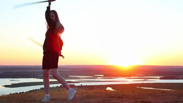 Swords Training  Young Woman Training with Two Swords on the Background of the Sunset