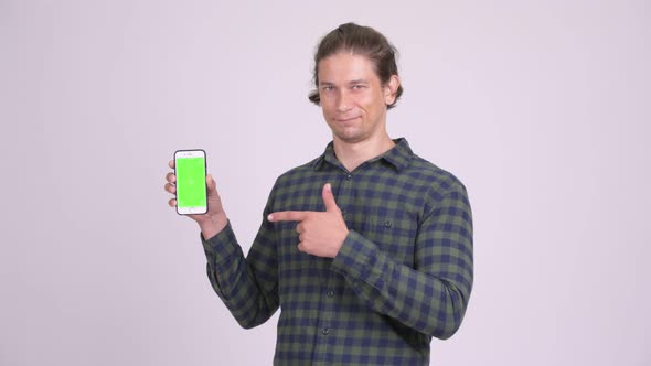 Handsome Hipster Man Showing Phone and Giving Thumbs Up