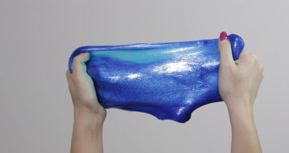 Woman Hands Playing with Oddly Satisfying Blue Slime Gooey Substance