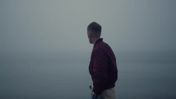 Sad Guy Walking Ocean Coast in Foggy Morning