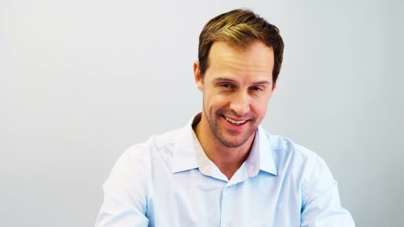 Portrait of happy dentist sitting at desk