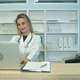 Smiling Medical Nurse Working on Laptop and Making Notes - VideoHive Item for Sale