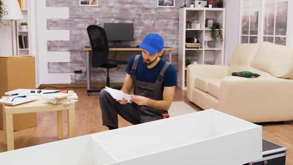 Furniture Assembly Worker Using Screwdriver