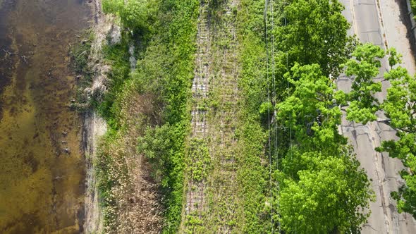 High bird's eye track of old train tracks running along Muskegon Lake.