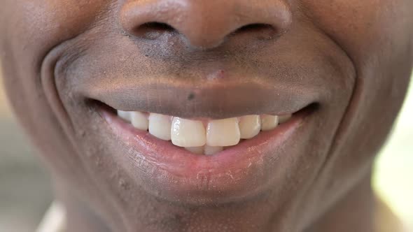 Close Up of Smiling Mouth of Young Young African Man